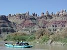 A turquoise raft floating past a group of rock spires