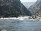White water rafts running a small rapid in a steep canyon