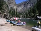 A rafting trip stopped for lunch at Elk Bar with red and white umbrella and perfect weather