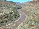 The brown Salt River winding through its canyon, with spotty vegetation on the steep cliffs and slopes of the canyon walls