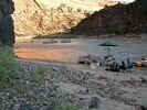 Evening light reflecting off the water beside a rafting trip campsite