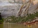 Two inflateable kayaks gliding through the shadowy Yampa Canyon above Warmsprings Rapid