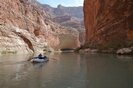 Whitewater raft floating toward Redwall Cavern in Grand Canyon