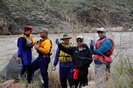 Whitewater rafters toasting the camera beside the Colorado River