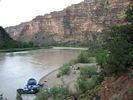 Rafts tied up at a beach with the Green River disappearing into Desolation Canyon beyond