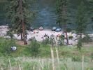 Looking down across a grassy hillside at Big Squaw Camp on the Salmon River