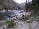 Looking upstream at a rafting group cooking a meal at Rugged Creek Camp on the Main Salmon