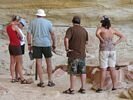 Four people looking at a cave on the Yampa river.