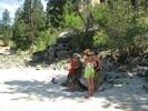 Members of a rafting party standing on a beach
