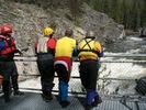 Four members of a rafting party scouting Dagger Falls.