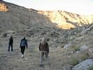 Three women hiking up a slope in Gray Canyon, Green River, Utah