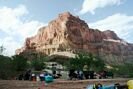 A rafting party camped at a picturesque river campsite