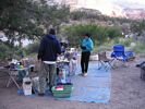 A man and a woman standing in a river kitchen that has a blue floor tarp