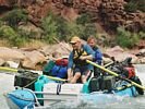 A couple on a cataraft running a rapid in Lodore Canyon