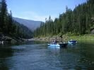 Blue catarafts on deep green water under a blue sky on the Main Salmon River