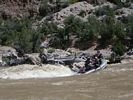 Paddle raft descending into a deep rapid