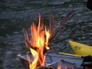 A chunk of strangly shaped driftwood burning in a campfire