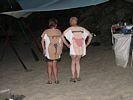 Same man a woman in bikini tee shirts, turned around to show the bikini design on the back