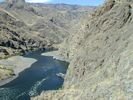 The view from high above of the dark blue Snake River winding through Hells Canyon