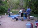 People setting up a river kitchen on top of a floor tarp