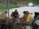 A group playing poker on a whitewater rafting trip