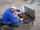 A man roasting meat on a bar-b-que